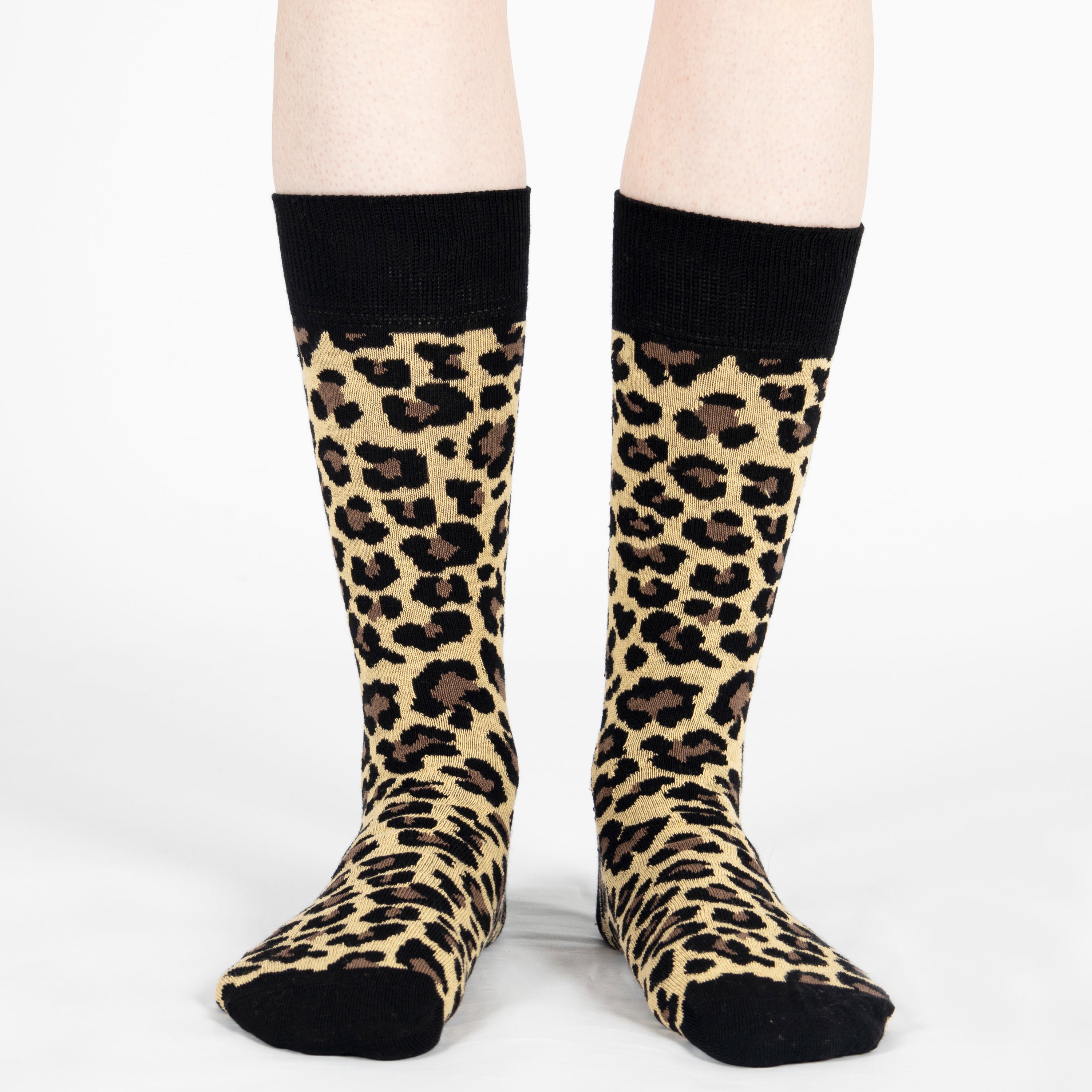 Leopard print socks with black cuffs on a white background