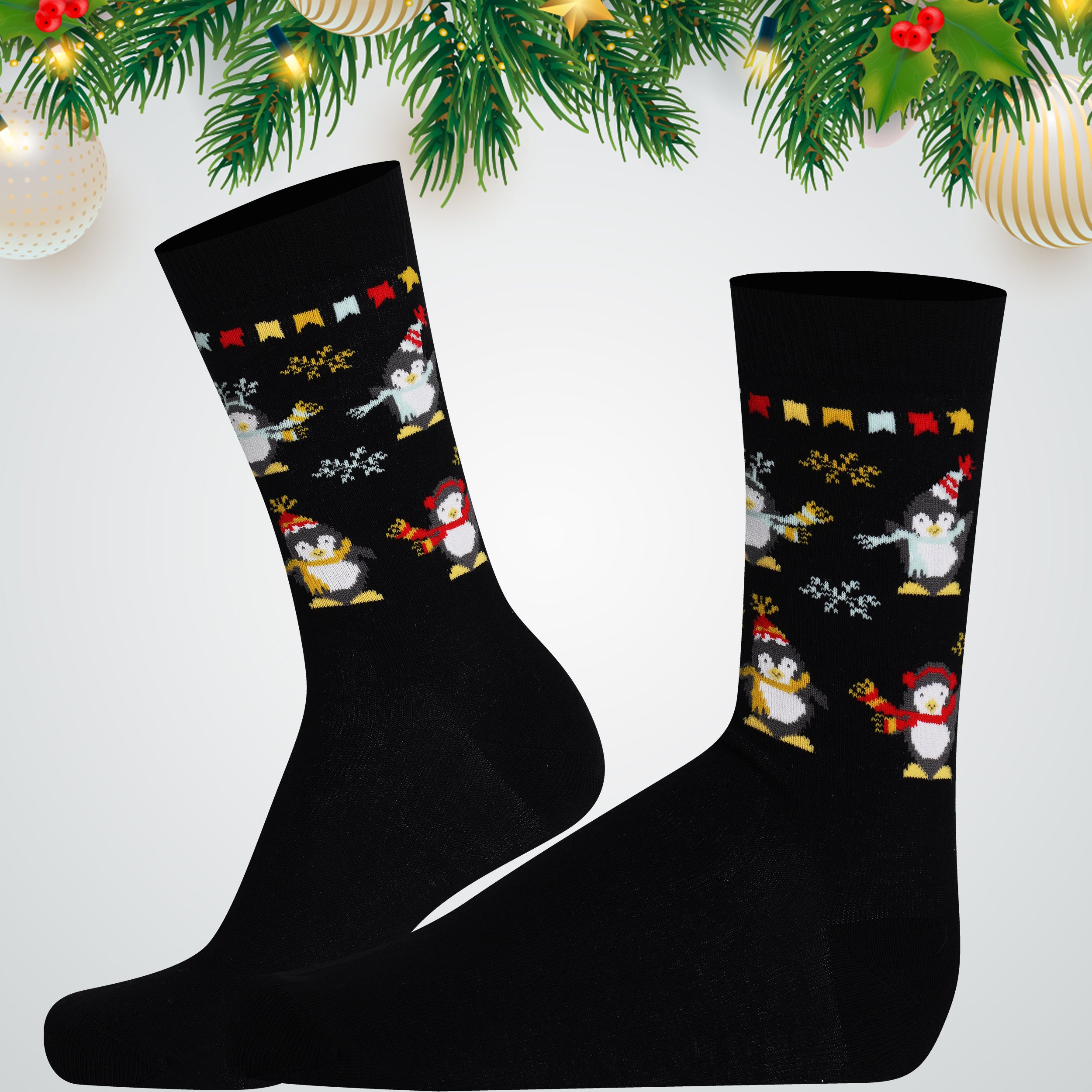 Black socks with penguin design on a white background with Christmas decorations.