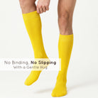 Unisex wearing yellow Mysocks knee-high combed cotton socks