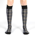 Tartan knee-high socks worn by a person on a white background