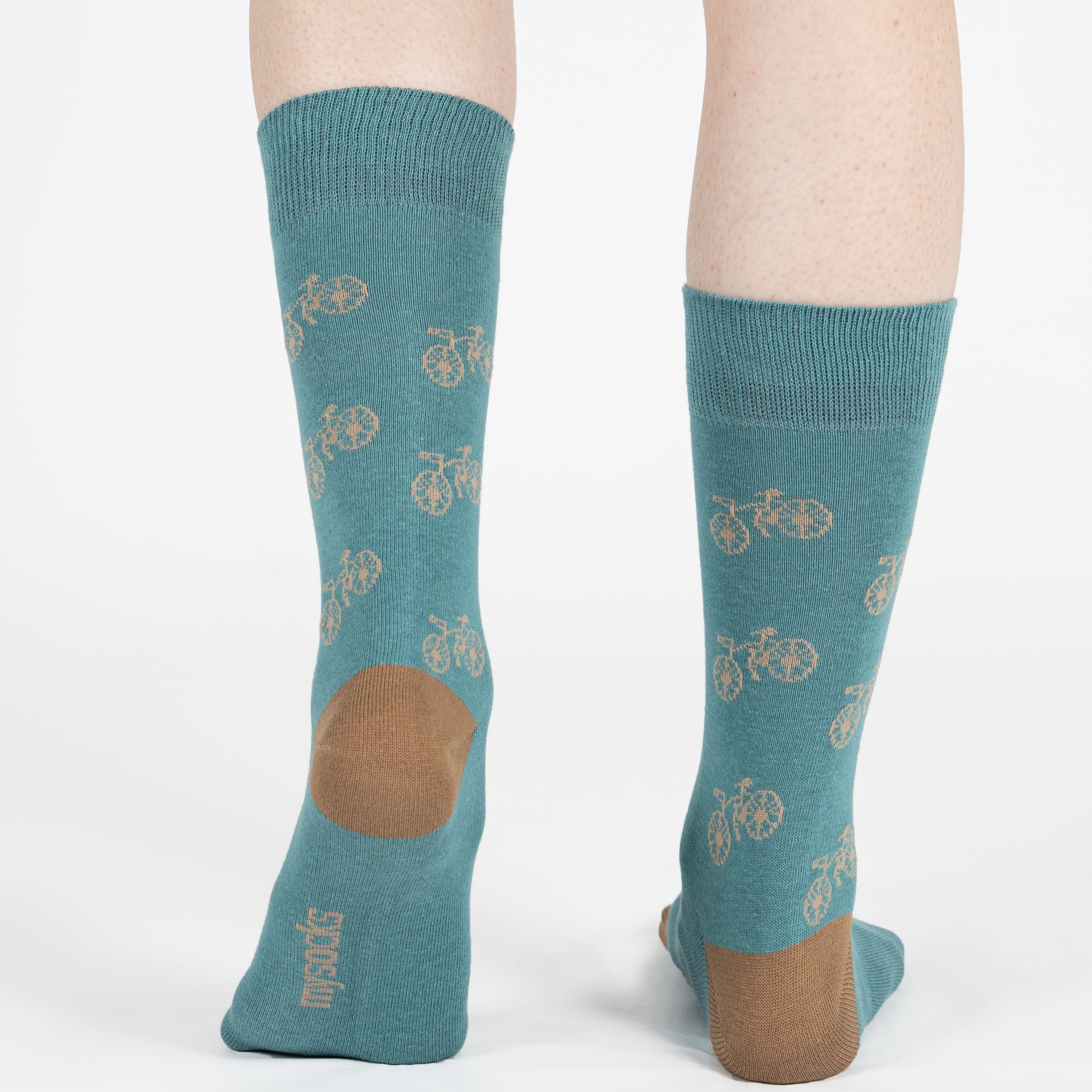 Mint unisex crew socks featuring a brown bicycle pattern and seamless toe design, made from premium combed cotton for men and women