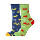 Two pairs of kids crew socks, one light blue with a dark blue crab pattern and one light green with a red crab pattern.