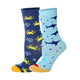 Two pairs of kids crew socks, one light blue with a dark blue shark pattern and one light green with a red crab pattern.