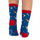Blue socks with space-themed design worn by a person on a white background