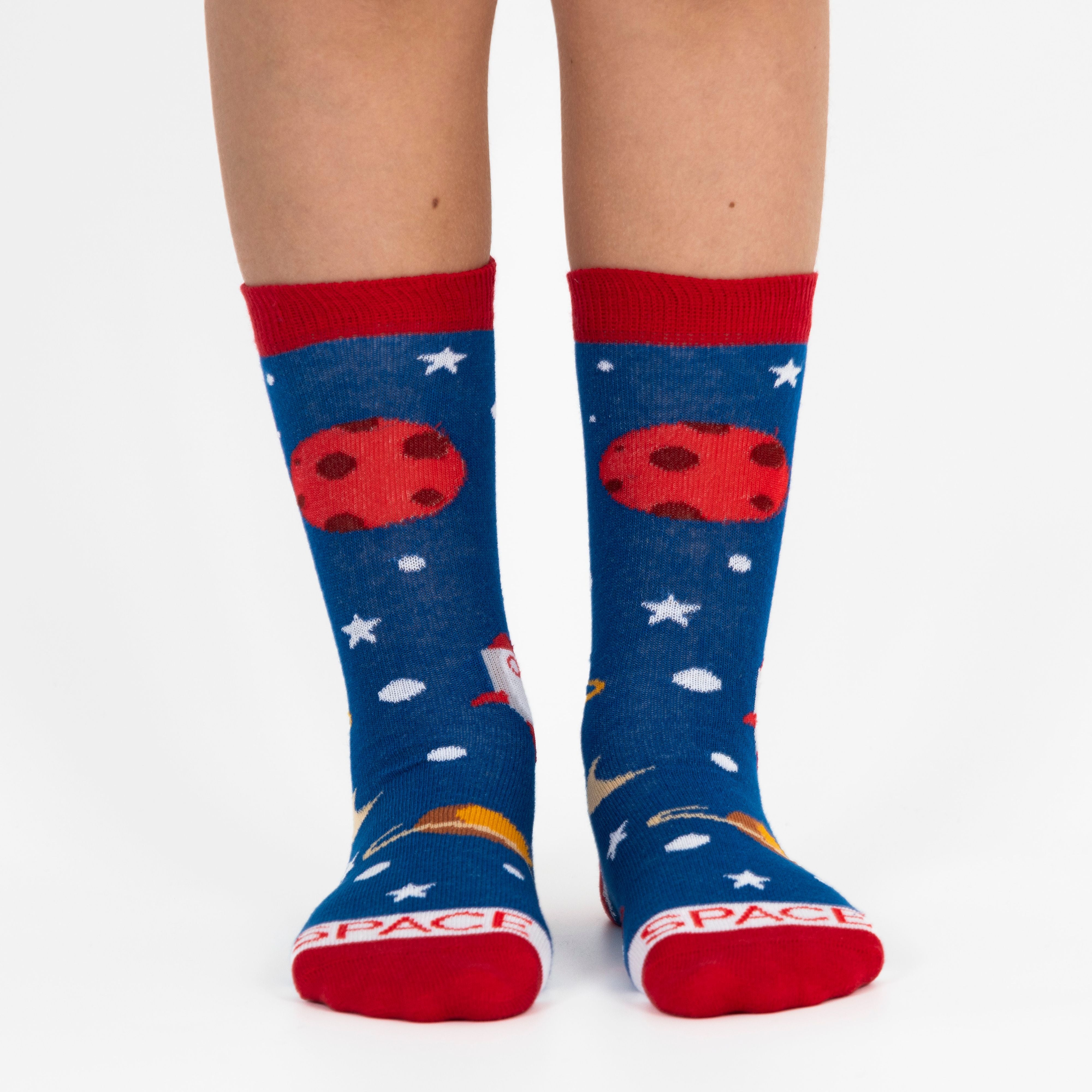 Blue socks with space-themed designs and red accents worn by a person on a white background