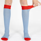 Light blue ribbed kids knee high socks with red cuffs, heels, and a seamless toe by Mysocks.