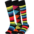 Three pairs of colorful knee-high socks on a white background