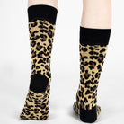 Leopard print socks with black cuffs and toes on a white background