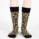 Leopard print socks with black cuffs on a white background